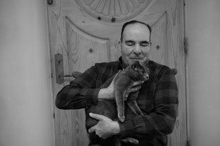 Al Cota holds Sasha in the office of Serious Play, Santa Fe, New Mexico.